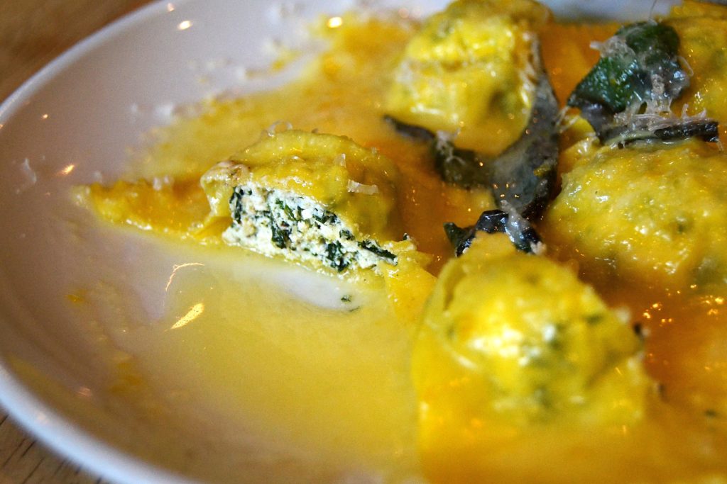 Inside ricotta spinach ravioli with butter sauce and sage